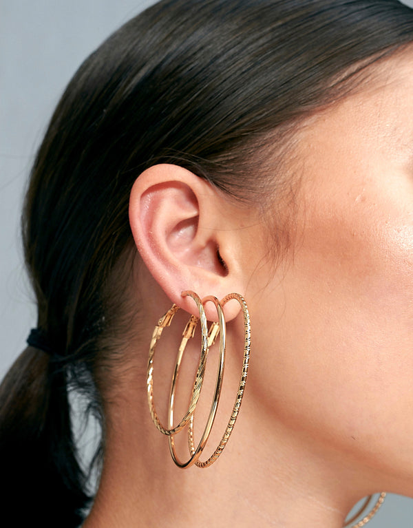 Set of textured gold plated hoop earrings, Crafted from polished zinc alloy.