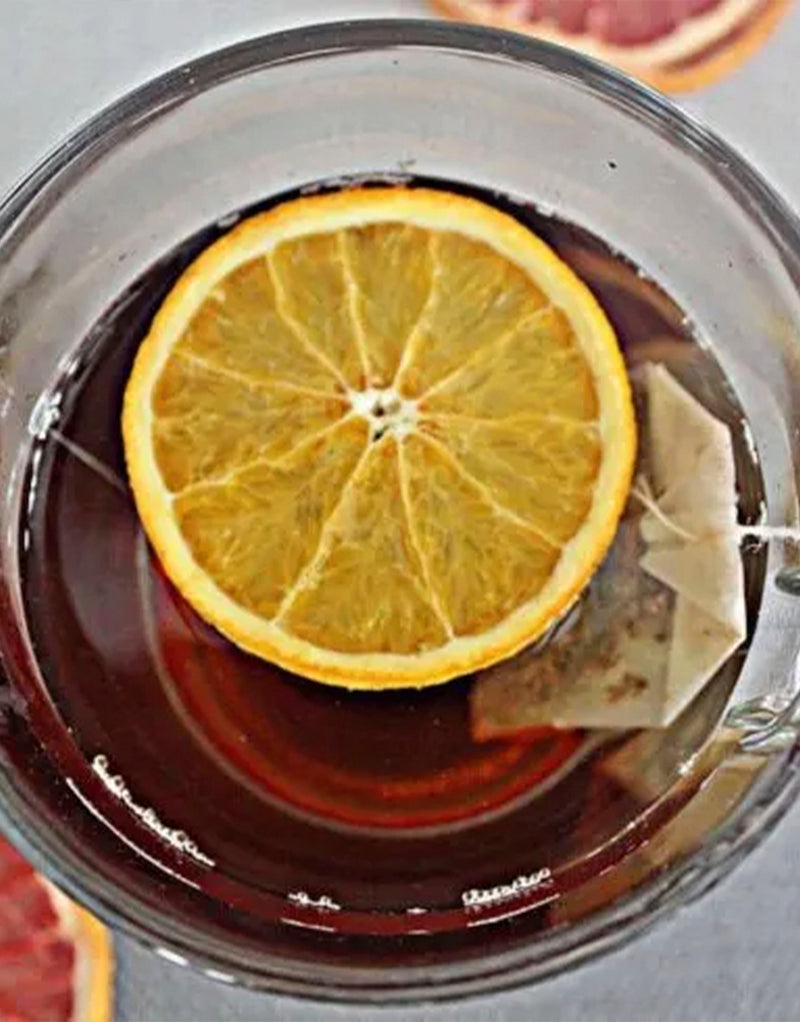 Image of a cup of tea garnished with dehydrated lemon wheel