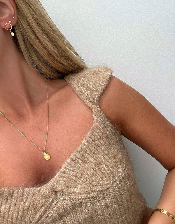 Letter M Necklace Gold - Stylishly displayed on a woman's neck