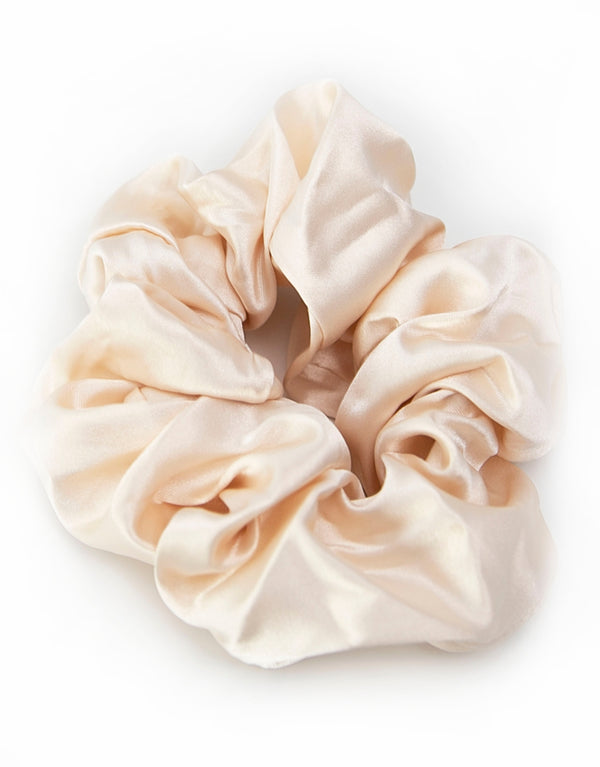 Satin scrunchies in light Champagne, soft and silky with a gentle sheen, perfect for adding a touch of elegance to hairstyles.