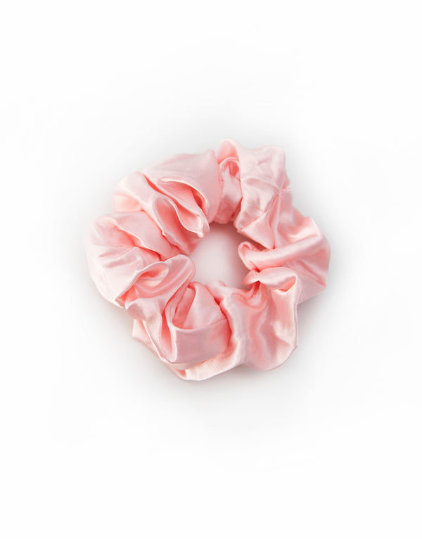 Satin scrunchies in light pink, soft and silky with a gentle sheen, perfect for adding a touch of elegance to hairstyles.