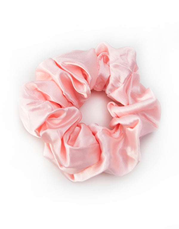 Satin scrunchies in light pink, soft and silky with a gentle sheen, perfect for adding a touch of elegance to hairstyles.