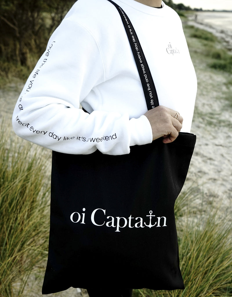 Limited Edition Organic Cotton Canvas Oi Captain Tote Bag is perfect for weekends to everyday.   Quality vinyl heat pressed Oi Captain logo on front and graphic type "Love the life you live and treat everyday like it's a weekend" on handle.  It is your ideal piece to wear any season, durable, sturdy, wonderful and fashionable way to carry things around.