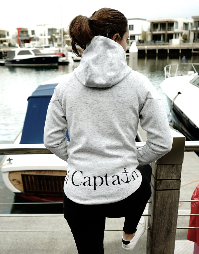 Elevate your casual weekend collection with the Carpe Diem Soft Essentials Hoodie. For all day comfort, this will be your go to.  Features trendy curved back, comfortable cotton bonded polar fleece lined hoodie jacket, drop shoulders add to this relaxed fit, and classic finishing touches, like zipped side pockets and piped trimmed edging. Quality vinyl heat pressed Oi Captain logo on front chest and lower back, and Licinia the label coastal collection set 2021 type graphic on sleeve.