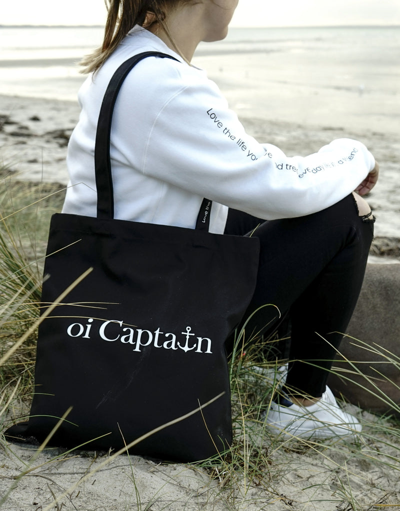 Limited Edition Organic Cotton Canvas Oi Captain Tote Bag is perfect for weekends to everyday.   Quality vinyl heat pressed Oi Captain logo on front and graphic type "Love the life you live and treat everyday like it's a weekend" on handle.  It is your ideal piece to wear any season, durable, sturdy, wonderful and fashionable way to carry things around.