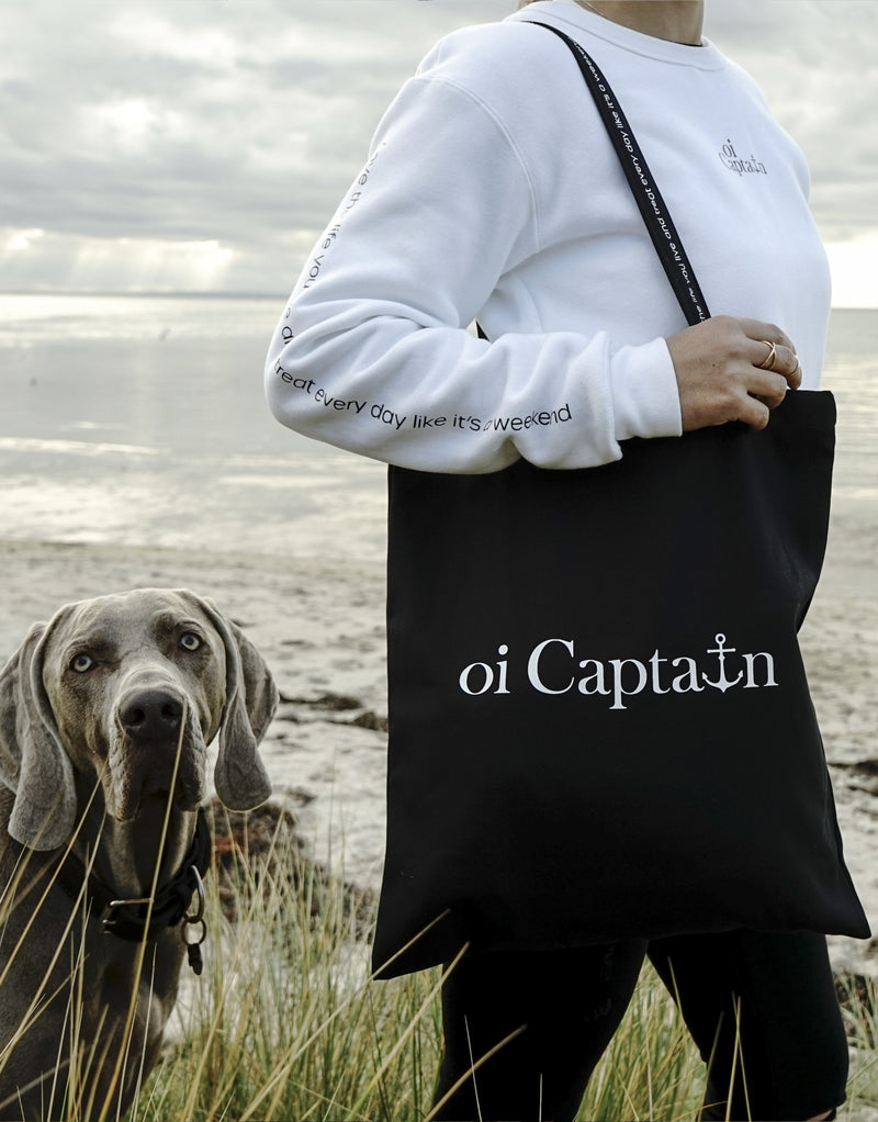 Limited Edition Organic Cotton Canvas Oi Captain Tote Bag is perfect for weekends to everyday.   Quality vinyl heat pressed Oi Captain logo on front and graphic type "Love the life you live and treat everyday like it's a weekend" on handle.  It is your ideal piece to wear any season, durable, sturdy, wonderful and fashionable way to carry things around.