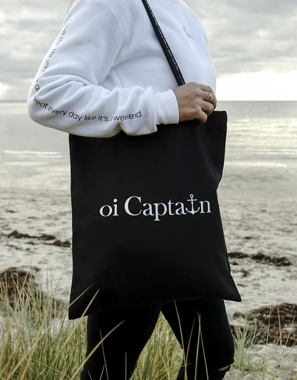 Limited Edition Organic Cotton Canvas Oi Captain Tote Bag is perfect for weekends to everyday.   Quality vinyl heat pressed Oi Captain logo on front and graphic type "Love the life you live and treat everyday like it's a weekend" on handle.  It is your ideal piece to wear any season, durable, sturdy, wonderful and fashionable way to carry things around.