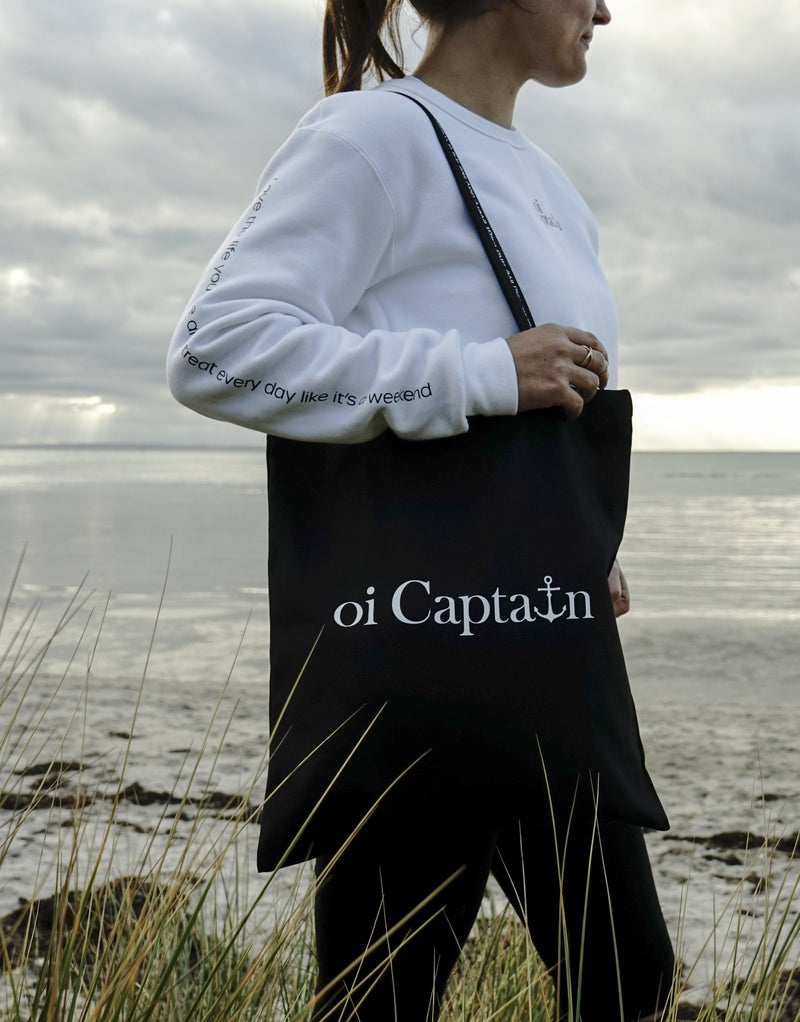 Limited Edition Organic Cotton Canvas Oi Captain Tote Bag is perfect for weekends to everyday.   Quality vinyl heat pressed Oi Captain logo on front and graphic type "Love the life you live and treat everyday like it's a weekend" on handle.  It is your ideal piece to wear any season, durable, sturdy, wonderful and fashionable way to carry things around.