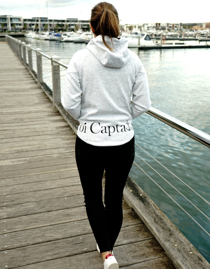 Elevate your casual weekend collection with the Carpe Diem Soft Essentials Hoodie. For all day comfort, this will be your go to.  Features trendy curved back, comfortable cotton bonded polar fleece lined hoodie jacket, drop shoulders add to this relaxed fit, and classic finishing touches, like zipped side pockets and piped trimmed edging. Quality vinyl heat pressed Oi Captain logo on front chest and lower back, and Licinia the label coastal collection set 2021 type graphic on sleeve.